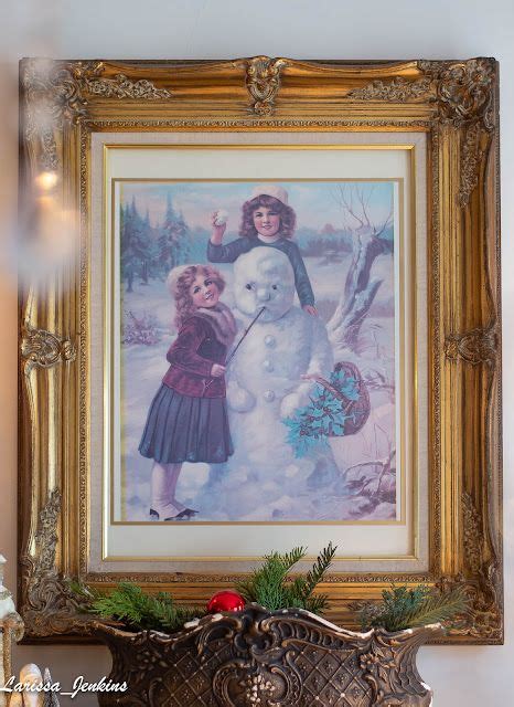 a painting hanging on the wall above a mantel with a snowman and girl