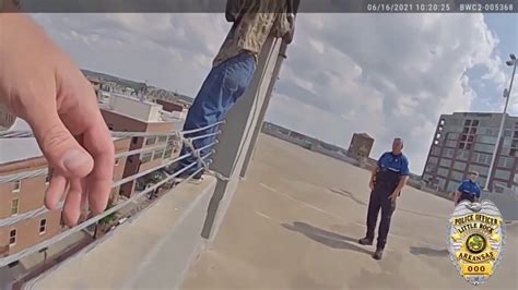 Little Rock police officers pull man from ledge of River Market parking ...