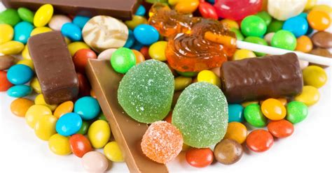 A variety of candies and sweets on a white background. - Austin Dental ...