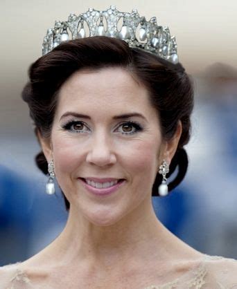 a woman wearing a tiara and smiling at the camera