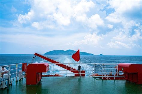 Premium Photo | The flag of vietnam red flag with a gold star fluttering on ship in the con dao ...