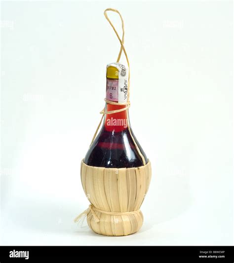 a classic italian chianti red wine bottle on a white cut out background Stock Photo - Alamy