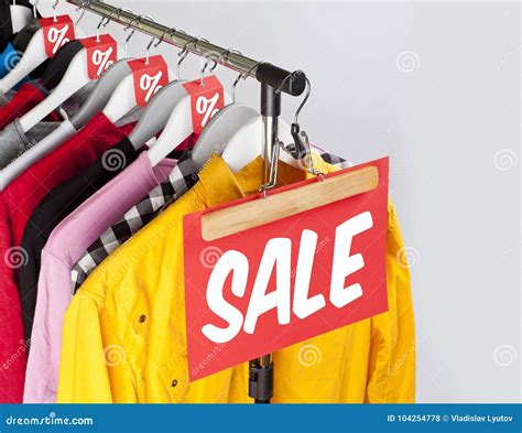 Sale in a Clothing Store - Discount Sign at a Clothes Rack. Stock Photo ...