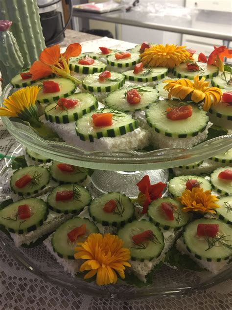 Cucumber sandwiches garnished with edible flowers: nasturtiums and ...