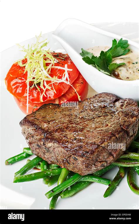 Grilled beef steak with vegetable garnish. Hearty steak dinner Stock Photo - Alamy