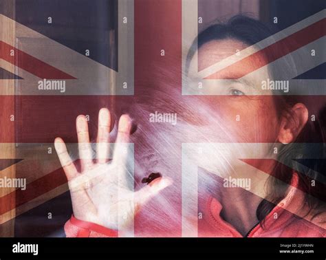 Woman looking out of window with UK flag overlayed. Conept image; female depression, domestic ...