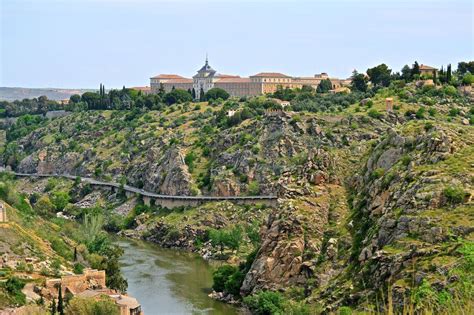 A cliff side road along the Tagus River heading into Toledo, Spain ...