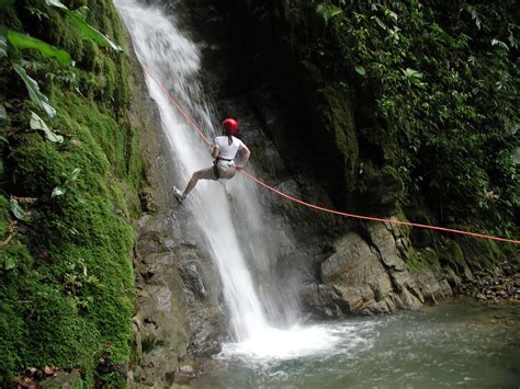 Adventure activities available in Costa Rica. Canyoning in a waterfall at La Fortuna near Arenal ...