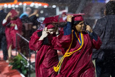 Harrison High School seniors finish graduation ceremony in a rainstorm