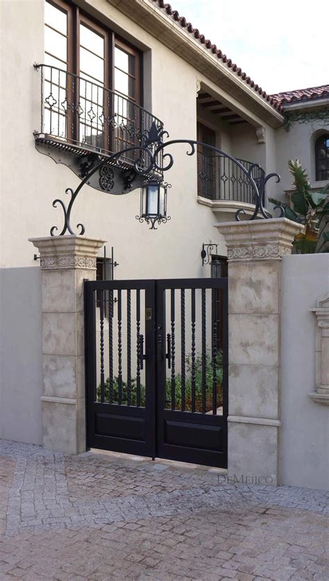 A classic and custom wrought iron entry gate, complimented by an accent arch, is an eye catching ...