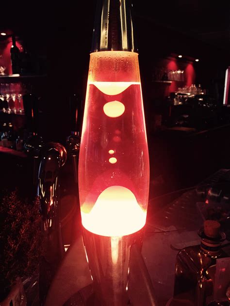 a red light that is on top of a glass vase with some lights in it