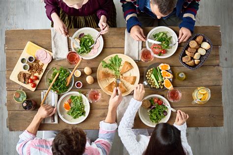 Family Eating At Dinner Table Stock Photo - Download Image Now - iStock