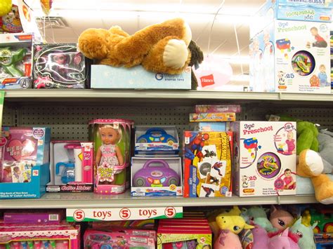 stuffed animals and toys are on display in a toy store's shelves with ...