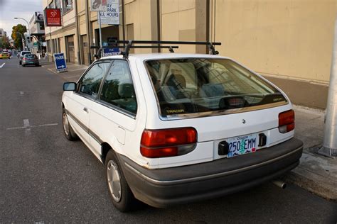 OLD PARKED CARS.: 1987 Mercury Tracer hatchback.