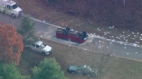 Truck flips over on highway exit ramp