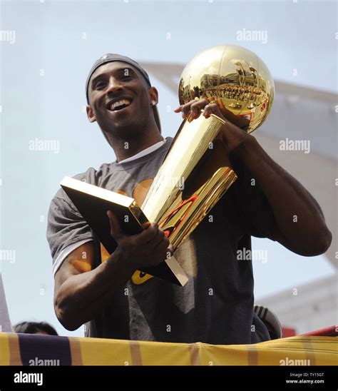 Kobe Bryant holds the championship trophy as the 2009 NBA Champion ...