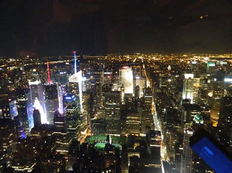 an aerial view of new york city at night from the top of the empire ...