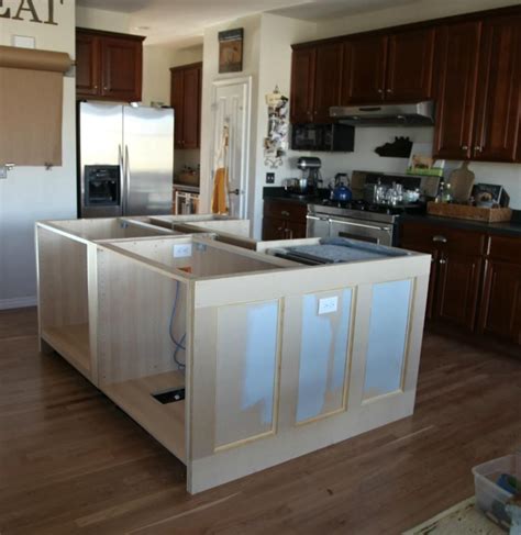 a kitchen with wooden floors and cabinets in it's center island, surrounded by wood flooring