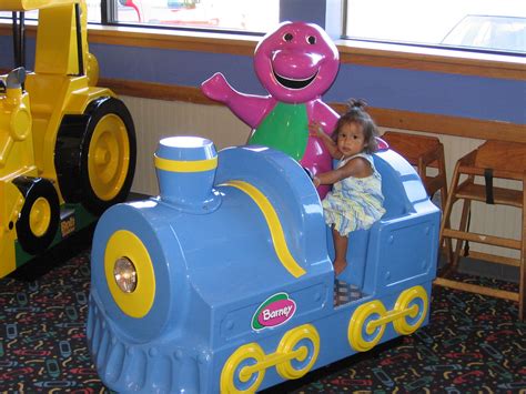 Gabby riding the Barney ride at Chuck-E-Cheese | Chris Johnson | Flickr