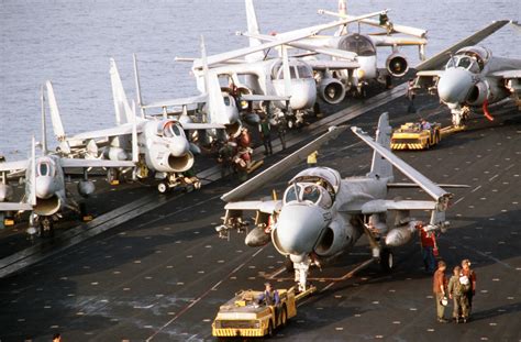 A-6E Intruder aircraft are towed by MD-3A tow tractors during flight operations aboard the ...