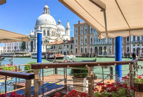 a view of the grand canal from an outdoor cafe in venice, italy with ...