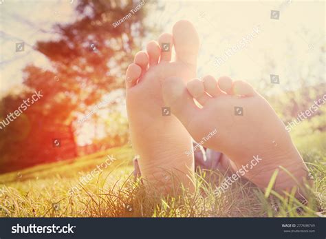 Barefoot Child Lying On Green Grass Stock Photo (Edit Now) 277698749