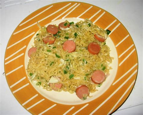 Indomie Noodles Recipes With Green Peppers And Cabbage Cooked With some Chopped Sausages