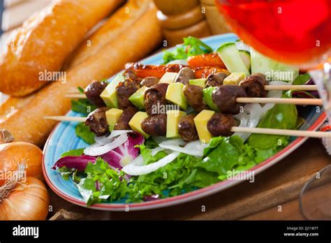 Chicken hearts skewers with avocado Stock Photo - Alamy