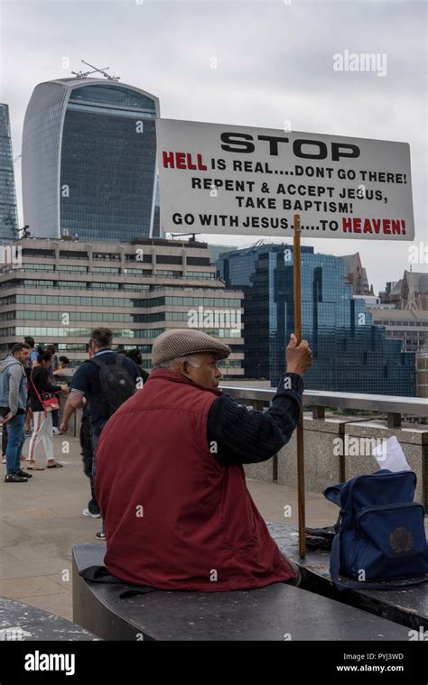 a street preacher in the centre of London near the city of London holding a placard or notice ...