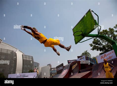 Basketball tricks team perform their slam dunk trick, flying through the air at Happy Valley ...