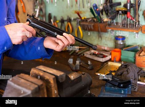 Dismantling and repair of combat pistol in weapons workshop Stock Photo - Alamy