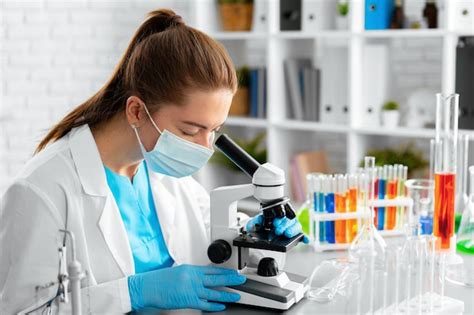 Premium Photo | Young woman scientist using microscope in laboratory close up