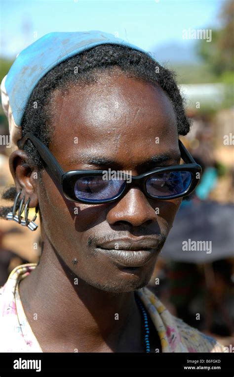 Man wearing black horn-rimmed glasses, portrait, at the markets in Dimeka, Ethiopia, Africa ...