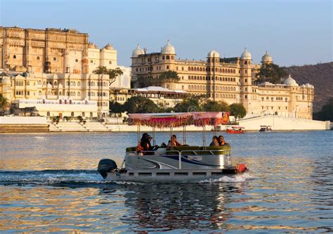 Tourists in Boat Floating on Pichola Lake Along Udaipur City Palace Complex in Rajasthan, India ...