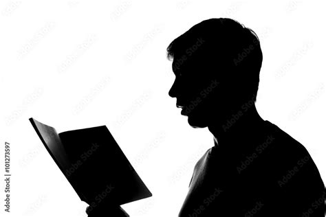 Young man reading a book - silhouette Stock Photo | Adobe Stock