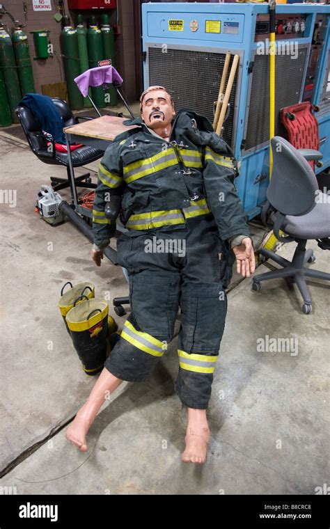 A firefighter training dummy with humorous mustache and hair drawn on ...