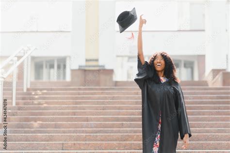 Excited African American woman at her graduation. Stock Photo | Adobe Stock