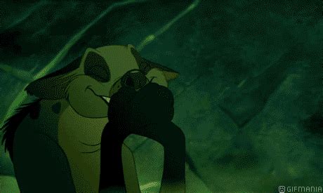 the lion and the person are kissing in front of a green background with ...