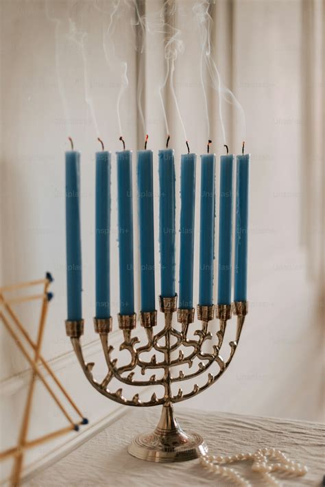 A lit menorah with a chain of candles photo – Menorah Image on Unsplash