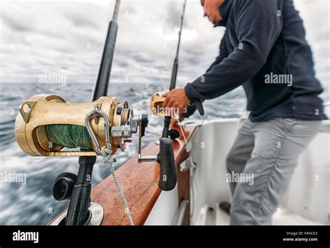 Spain, Asturias, Fisherman on fishing boat on Cantabrian Sea Stock ...