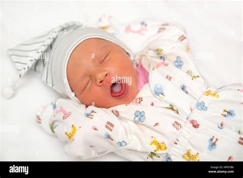 A cute newborn baby girl sleeping. Sweet little baby portrait. Use the photo to represent life ...