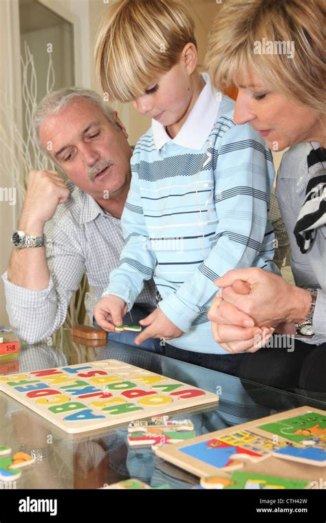 Family completing a puzzle together Stock Photo - Alamy