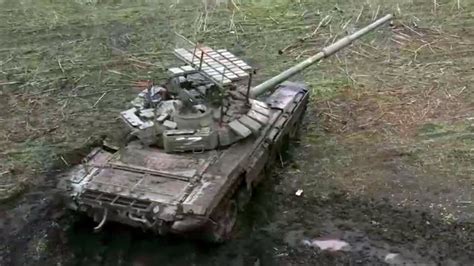 Russian Tank With ‘Cope Cage’ Covered In Explosive Reactive Armor Emerges