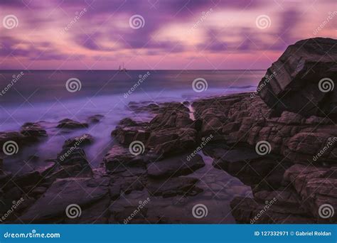 Cliff on Shore of Ocean in Sunset Stock Image - Image of picturesque, pink: 127332971