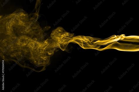 Gold smoke on black background,movement of gold smoke, Abstract gold ...