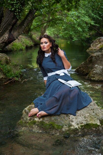 Premium Photo | Girl with a book on the river