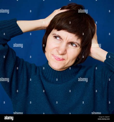 Portrait of mature woman in distress, close-up. Agitated tensed face ...