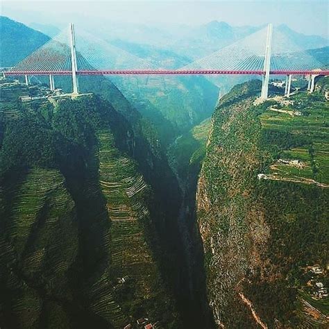 an aerial view of a bridge in the mountains