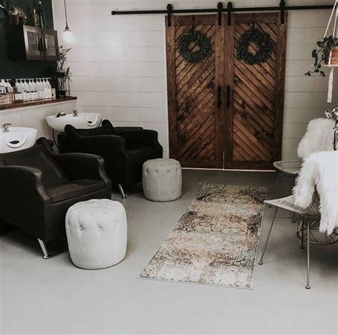 a living room filled with furniture next to a wooden door and two ...