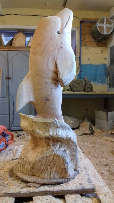 Chainsaw carved dolphins by Rob Waitt@Raw Edge Carving | Chainsaw wood carving, Wood sculpture ...